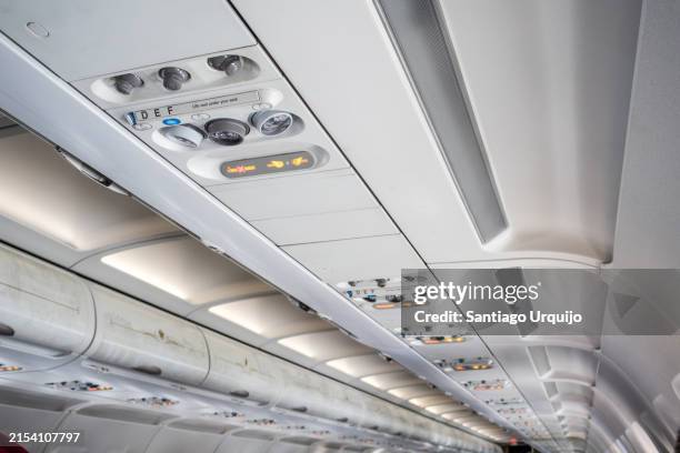 fasten seat belt signs inside an airplane - push button stock pictures, royalty-free photos & images