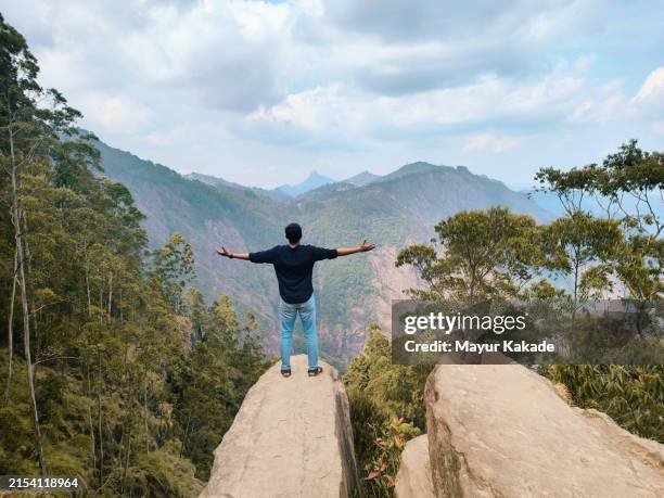 young man admiring view at dolphin's nose, kodaikanal, tamilnadu - south stock pictures, royalty-free photos & images