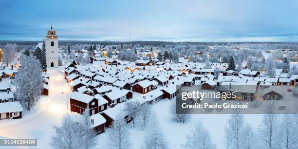 panoramic aerial view of gammelstad church town seen in winter at dusk, lulea, sweden - poolklimaat stockfoto's en -beelden