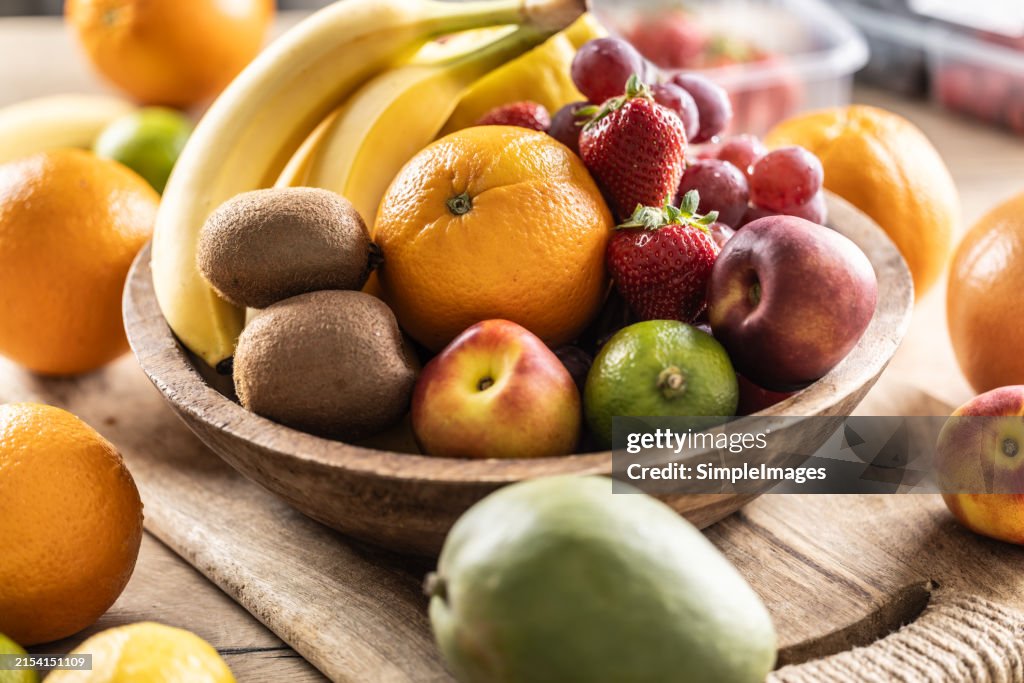 Fresh fruit in a wooden bowl. Concept of healthy nutrition.