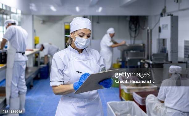 foreperson working at an industrial butchery taking inventory - inspector stock pictures, royalty-free photos & images