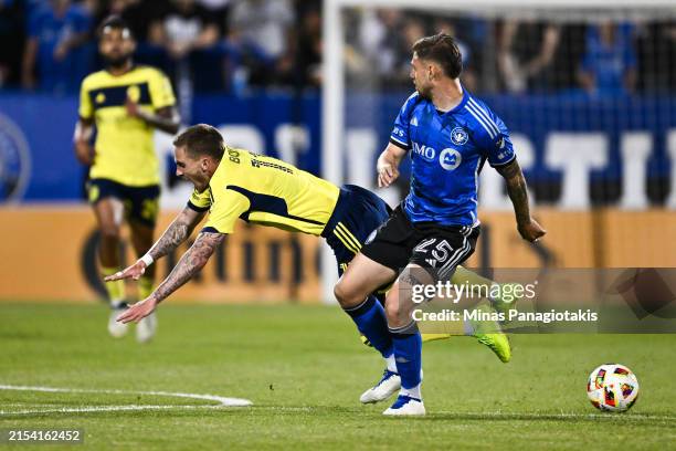 Gabriele Corbo of CF Montréal takes down Tyler Boyd of Nashville SC during the second half at Saputo Stadium on May 25, 2024 in Montreal, Quebec,...