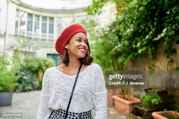 woman with red beret on street in paris, france - beret stock pictures, royalty-free photos & images