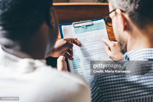 businessmen or hr managers review resume information. - currículum vitae fotografías e imágenes de stock