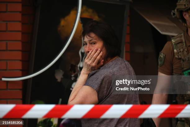 Woman is crying near an office building destroyed by a Russian missile strike in central Kharkiv, Ukraine, on May 25, 2024. NO USE RUSSIA. NO USE...