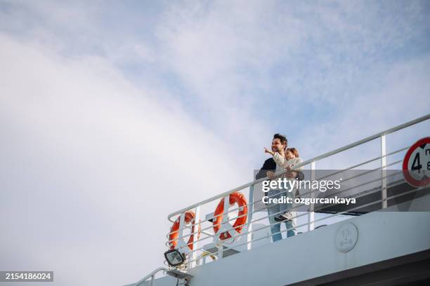 girl traveling by ship with her father and looking seagull - navio de passageiros imagens e fotografias de stock