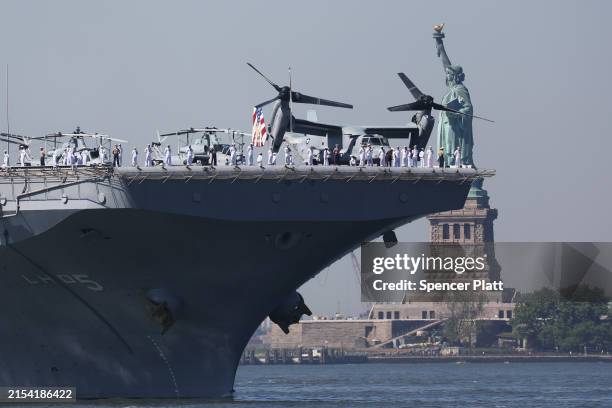 The USS Bataan sails past the Statue of Liberty as it arrives with the Parade of Ships into New York Harbor during the start of the 36th annual Fleet...