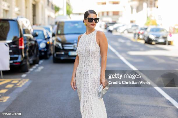 Gili Biegun wears silver Bottega Veneta bag, laced sleeveless dress during the 77th Cannes Film Festival on May 22, 2024 in Cannes, France.