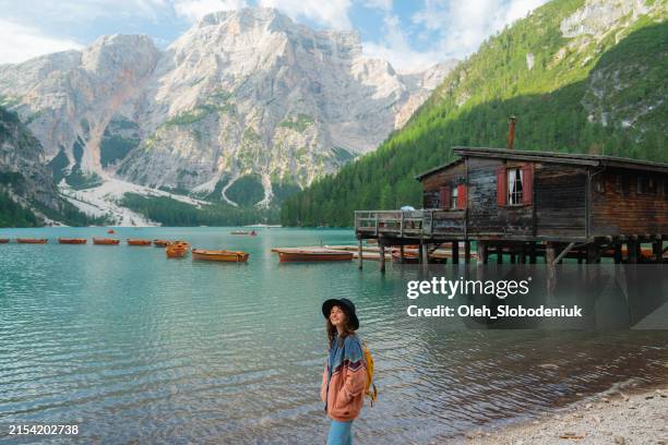 donna che cammina vicino al lago di braies nelle dolomiti - lago di braies foto e immagini stock