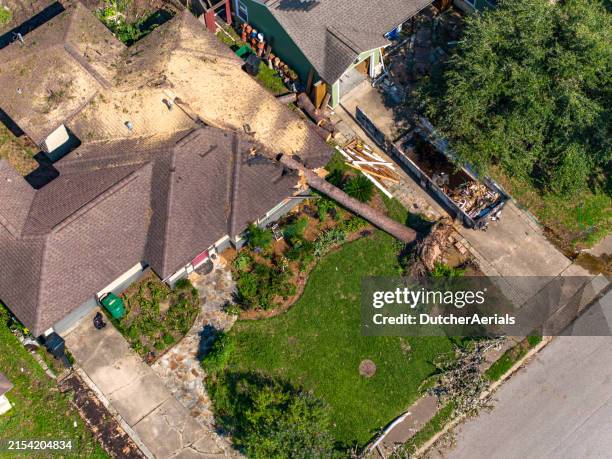 aerial view of tree falling on house after storm in houston - home insurance stock pictures, royalty-free photos & images