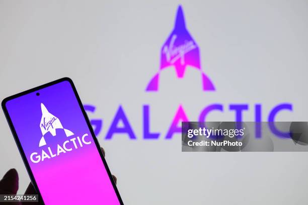 The Virgin Galactic logo is being displayed on a smartphone with Virgin Galactic Holdings visible in the background in this photo illustration in...