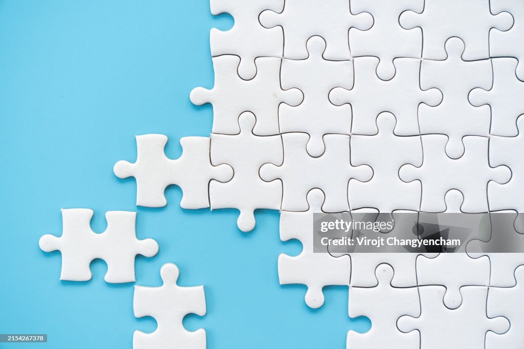 White puzzle jigsaw on blue background