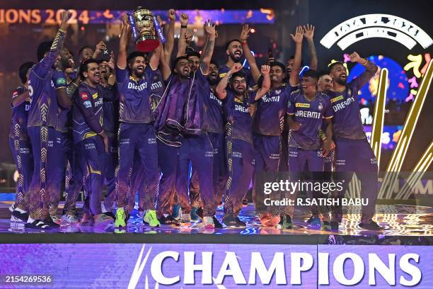 Kolkata Knight Riders' players celebrate with the trophy after winning the Indian Premier League Twenty20 final cricket match against Sunrisers...