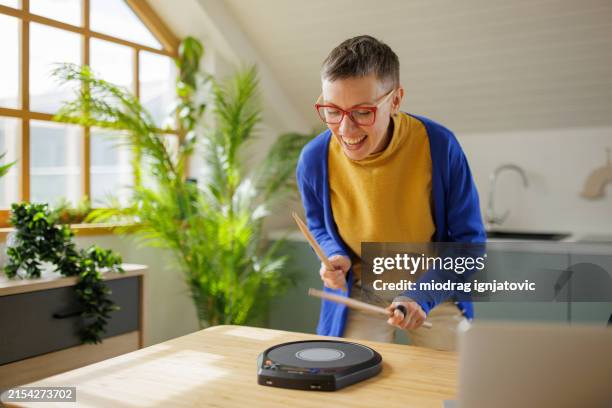 woman using a practice drum pad at home - drummer stock pictures, royalty-free photos & images