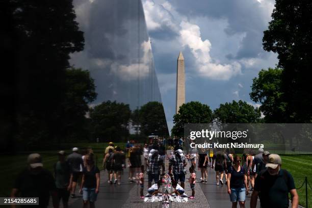 People visit the Vietnam Veterans Memorial on May 26, 2024 in Washington, DC. The wall, designed by Maya Lin and completed in 1982, is a tribute to...