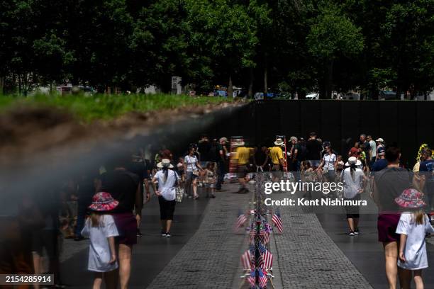 People visit the Vietnam Veterans Memorial on May 26, 2024 in Washington, DC. The wall, designed by Maya Lin and completed in 1982, is a tribute to...