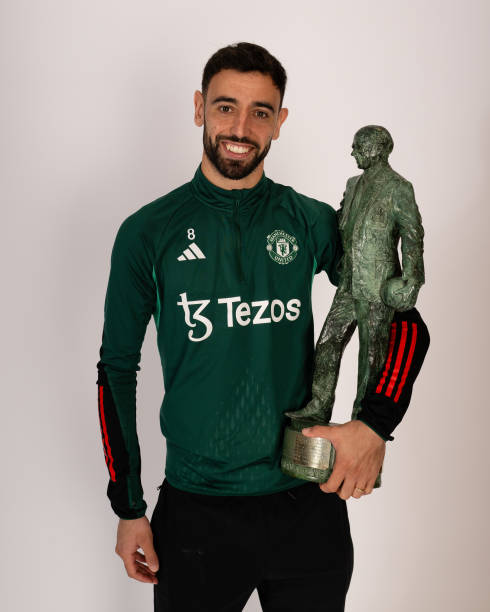Bruno Fernandes of Manchester United poses with his Sir Matt Busby Player of the Year award at Carrington Training Ground on May 23, 2024 in...