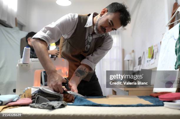 tailor in his sewing workshop - tailor stock pictures, royalty-free photos & images