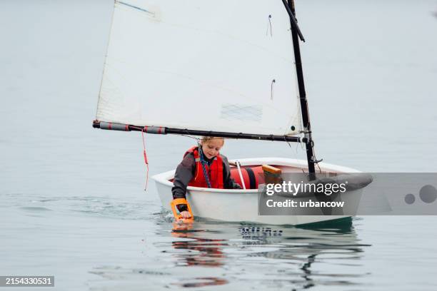 young girl sailing - sailing dinghy stock pictures, royalty-free photos & images