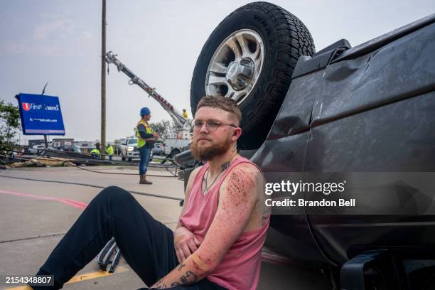 Year-old Ryan Leamer sits by his truck following a tornado on May 23, 2024 in Temple, Texas. "I was coming down Adams back towards my house when I...