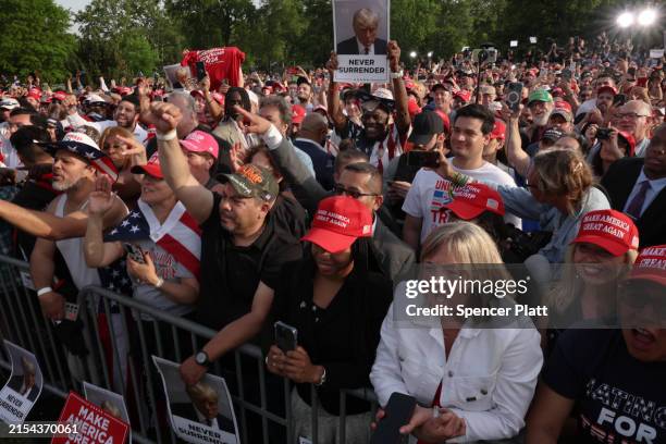 Supporters of former President Donald Trump watch as he holds a rally in the historical Democratic district of the South Bronx on May 23, 2024 in New...