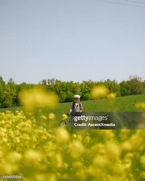 road bicyclist pauses in meadow - koblenz stock pictures, royalty-free photos & images