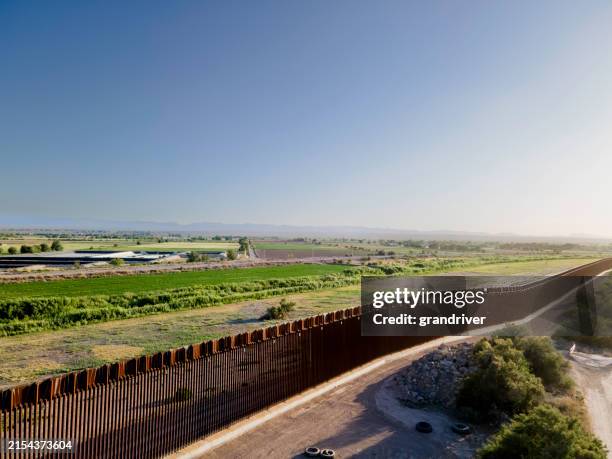 drone view international border wall at tornillo crossing in texas at dusk - homeland security building stock pictures, royalty-free photos & images