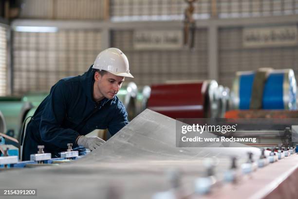 technician industrial worker inspecting forming aluminum metal sheet fabricating - hoja de aluminio fotografías e imágenes de stock