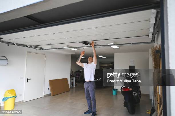 repair person working in garage. - deur stockfoto's en -beelden