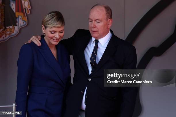 Prince Albert II of Monaco embraces Princess HSH Charlene Lynette Grimaldi on the podium after the F1 Grand Prix of Monaco .