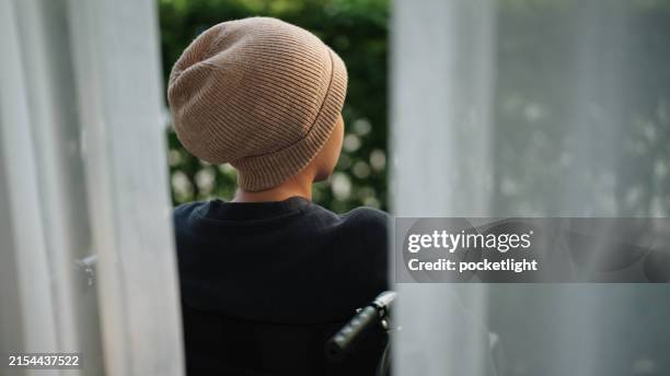 patient sitting on wheelchair. - cancer cells stock pictures, royalty-free photos & images