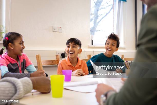 children thriving in group therapy - community center interior stock pictures, royalty-free photos & images