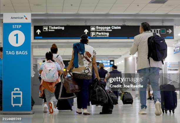 Travelers make their way through the Miami International Airport on May 24, 2024 in Miami, Florida. The Transportation Security Administration...