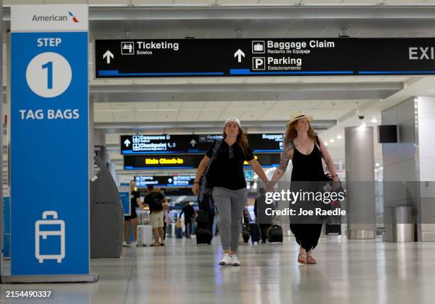 Travelers make their way through the Miami International Airport on May 24, 2024 in Miami, Florida. The Transportation Security Administration...