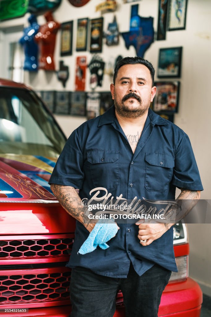 Mexican American man proudly displays his Low Rider Truck
