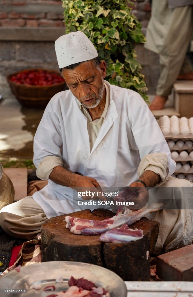 A Traditional Kashmiri chef cut lamb meat to prepare wazwan...