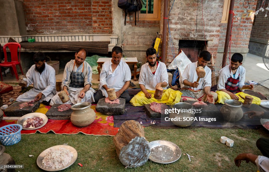 Traditional Kashmiri chefs smash lamb meat to prepare a dish...