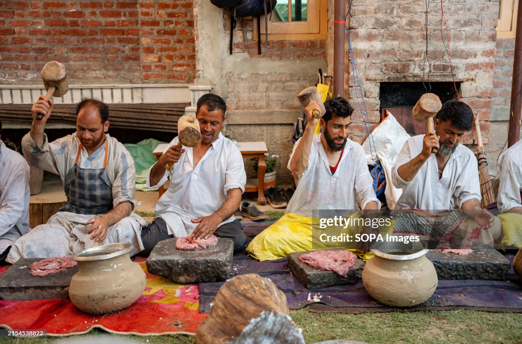 Traditional Kashmiri chefs smash lamb meat to prepare a dish...