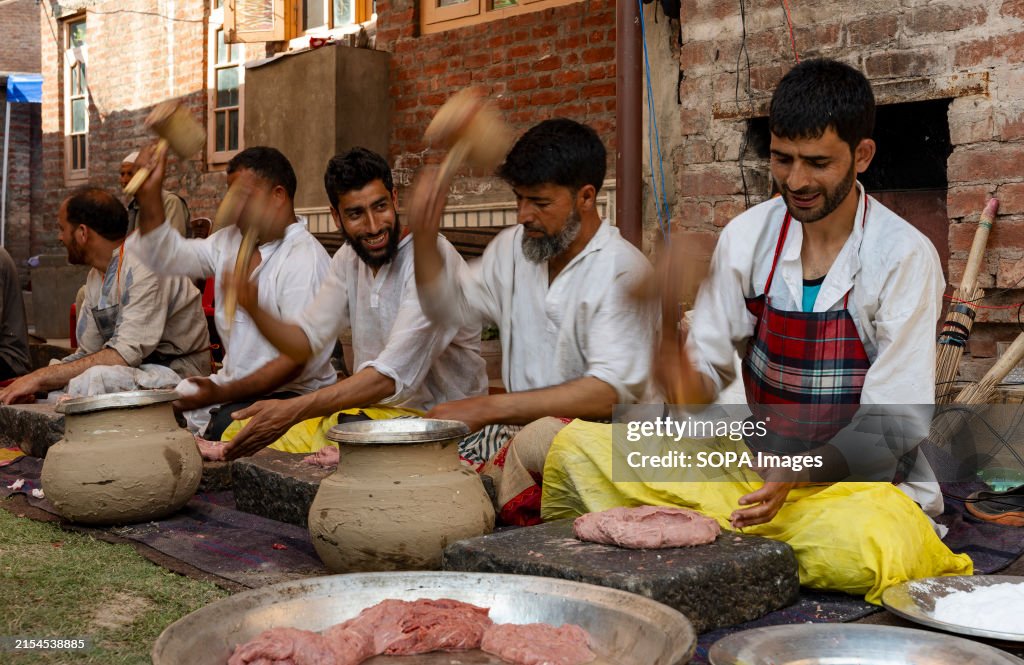 Traditional Kashmiri chefs smash lamb meat to prepare a dish...