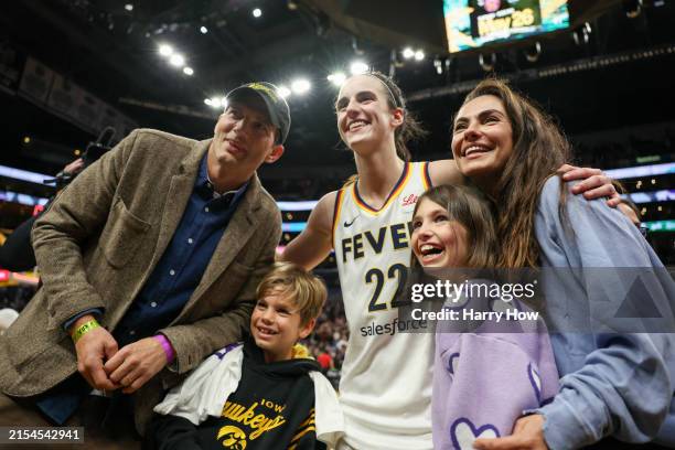 Caitlin Clark of the Indiana Fever poses for a photo with Ashton Kutcher and Mila Kunis after defeating the Los Angeles Sparks at Crypto.com Arena on...