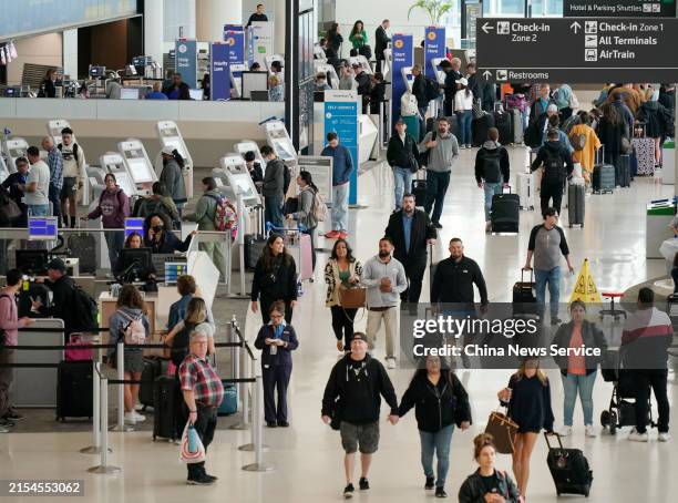 Passengers check in at San Francisco International Airport on May 24, 2024 in San Francisco, California. An estimated 43.8 million Americans will...