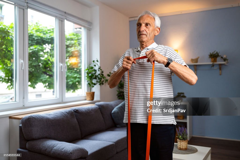 Senior man exercising at home