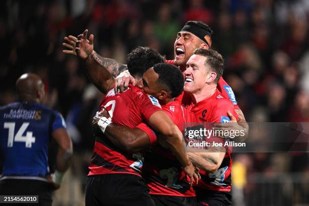Noah Hotham of the Crusaders celebrates with Sevu Reece, Codie Taylor and Dallas McLeod after scoring a try during the round 14 Super Rugby Pacific...