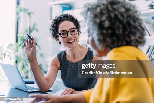 Colleagues discussing project at workplace. Colleagues discussing project at workplace.