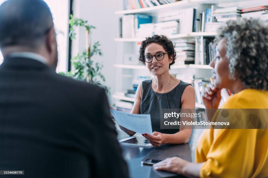 Group of business persons talking in the office.