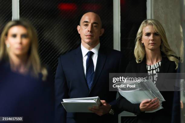 Attorney Emil Bove and Trump aide Natalie Harp look on as former U.S. President Donald Trump speaks to the media during his criminal trial at...