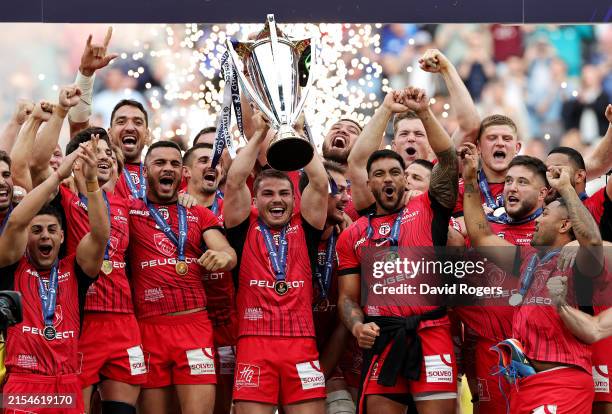 Antoine Dupont of Stade Toulousain lifts the Investec Champions Cup as he celebrates with teammates after their victory during the Investec Champions...
