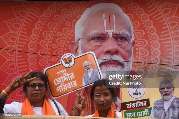 Supporters of the Bharatiya Janata Party are holding a cutout of a portrait of India's Prime Minister Narendra Modi ahead of the roadshow in...