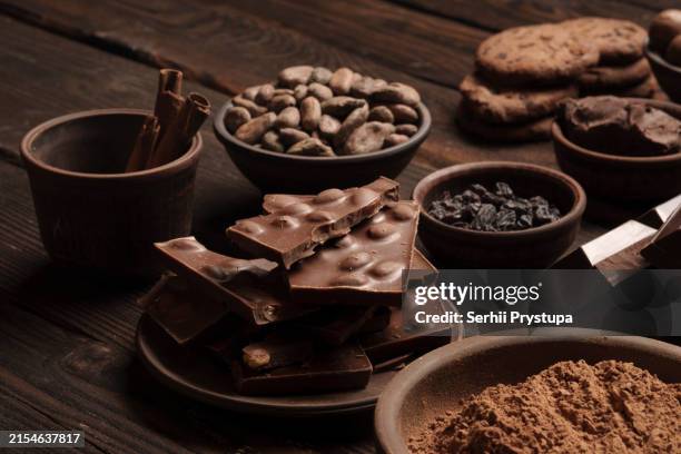 craft chocolate products with cocoa beans and nuts - schokolade stock-fotos und bilder