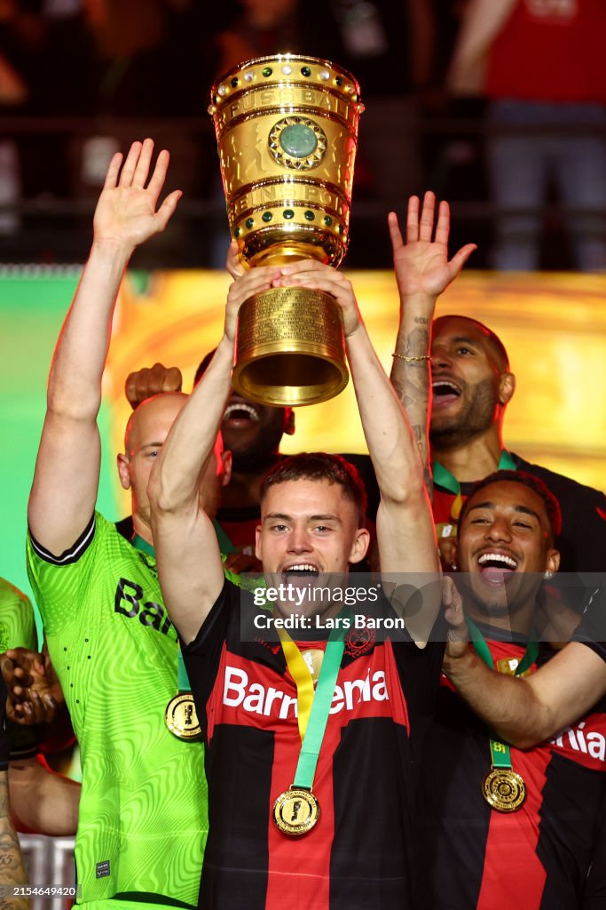 Florian Wirtz of Bayer 04 Leverkusen lifts the DFB-Pokal Trophy